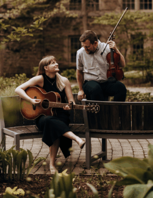 Feed The Ducks Band  in a courtyard, in front of old stone building